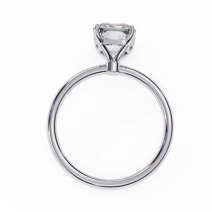 Close up of radiant cut solitaire diamond ring with detailed gold finish
