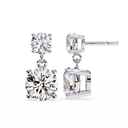 Angled view of round cut diamond dangle earrings in white gold