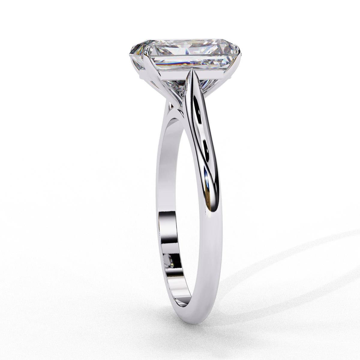 Close up of emerald cut solitaire diamond ring with refined prong details