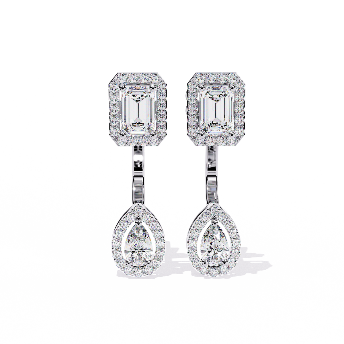 White gold halo drop earrings with emerald top and pear bottom worn look