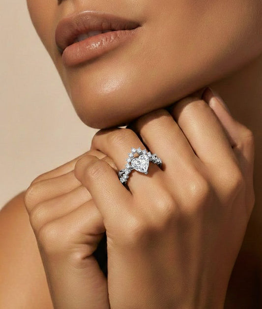 Hand wearing heart cut diamond ring with crown inspired side setting #wearthelook