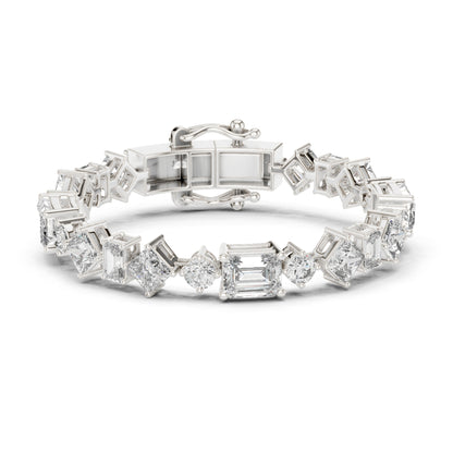 White gold tennis bracelet with emerald, princess and round cut diamonds