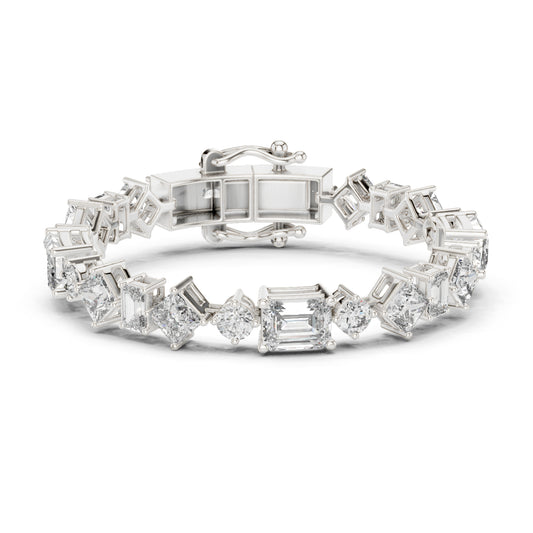 White gold tennis bracelet with emerald, princess and round cut diamonds