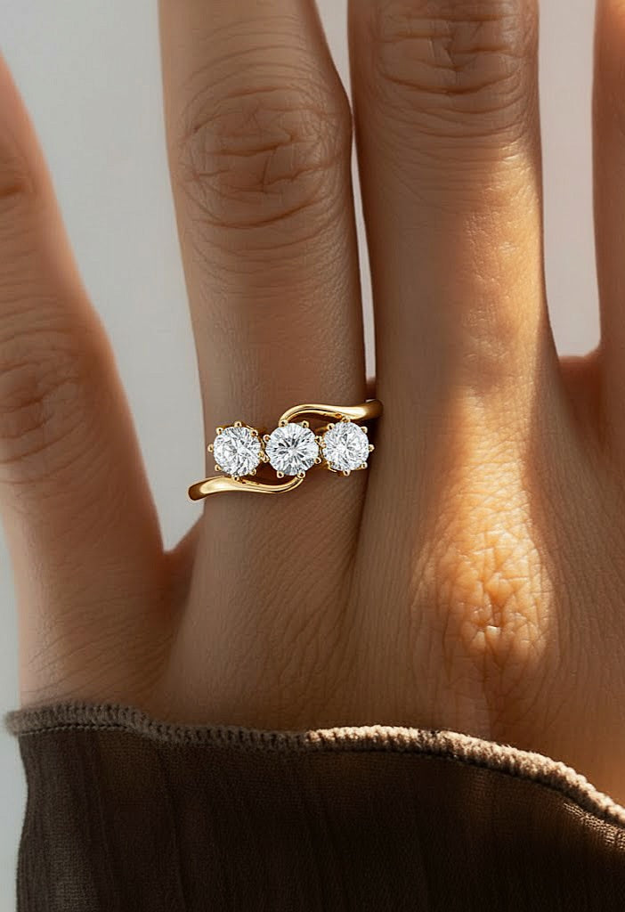 Three stone diamond wave ring worn on finger with rose gold finish