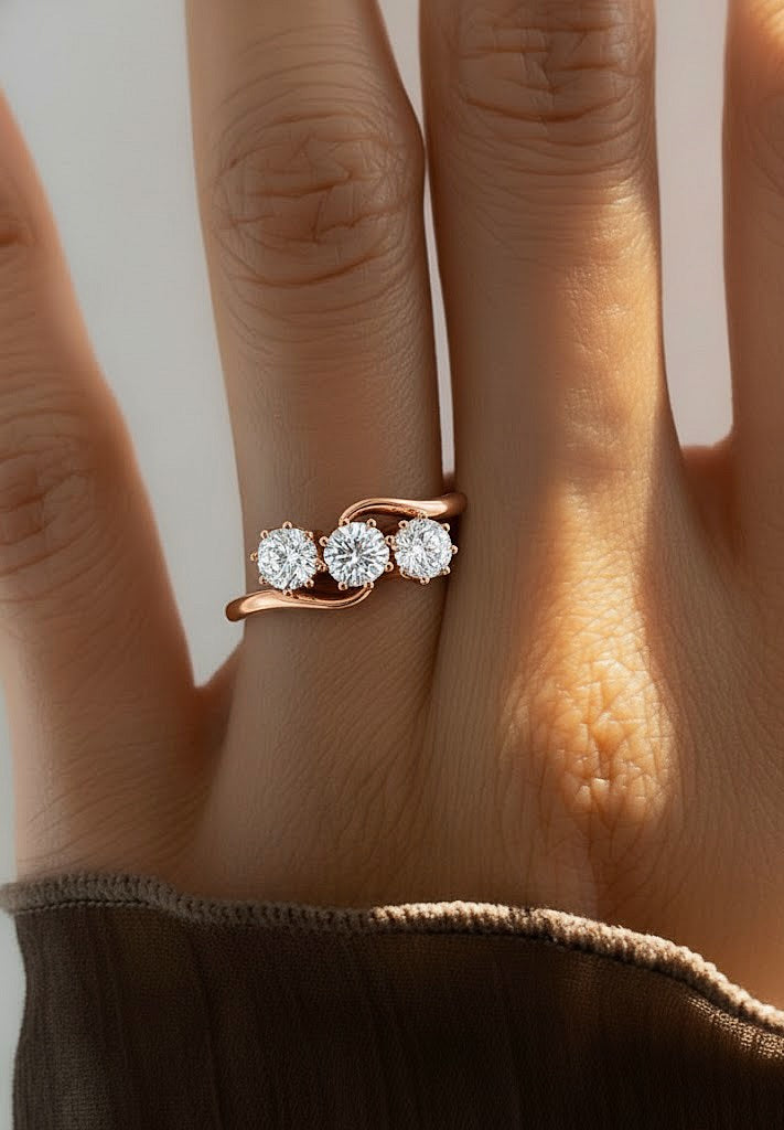 Hand wearing round cut lab diamond crossover ring with curved band
